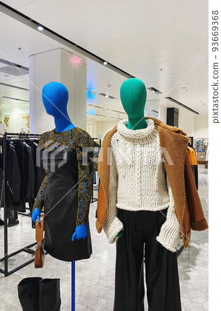 Women clothing on mannequins in a store. Inside the modern large-scale clothing store, which is selling women's clothes. Women clothing on mannequins in a store. Inside the modern large-scale clothing store, which is selling women's clothes. 93669368