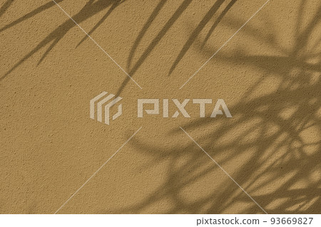Shadow of leaves on beige concrete wall texture background Shadow of leaves on beige concrete wall texture background 93669827