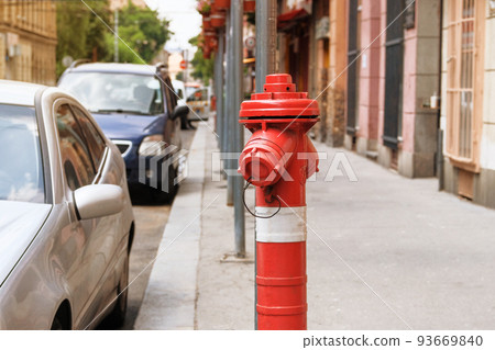 Red fire hydrant in city street. Fire hidrant for emergency fire access. Red fire hydrant in city street. Fire hidrant for emergency fire access. 93669840