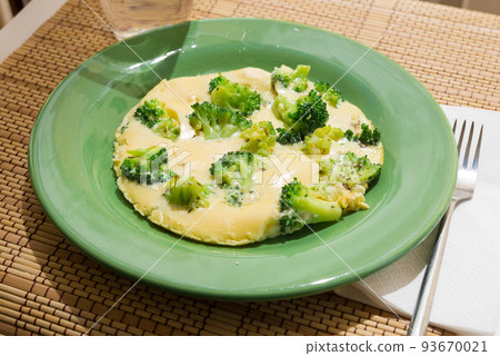 wholesome breakfast. omelet with broccoli on green plate 93670021