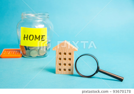Wooden house and glass jar with money Home. Real estate concept. Family budget planning. Investments, plans, savings. Mortgage and mortgage rates. Forecasts. Loan. Refinance home 93670178