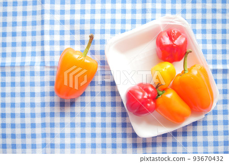 Yellow orange and red capsicum on white background  93670432