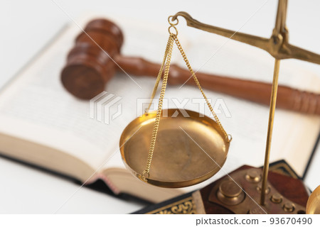 Scale and judge gavel on a wooden desk 93670490