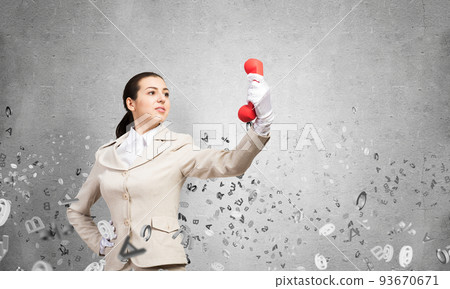 Woman keep at distance vintage red phone 93670671