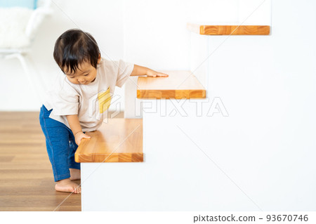 boy trying to climb stairs 93670746