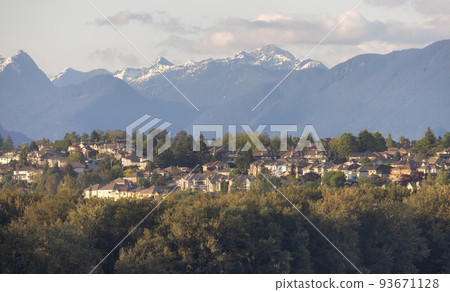 Residential Homes in a modern city with mountain peaks in background. Residential Homes in a modern city with mountain peaks in background. 93671128