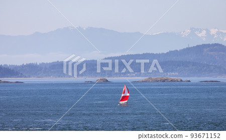 Sailboat in Canadian Landscape by the ocean and mountains. 93671152