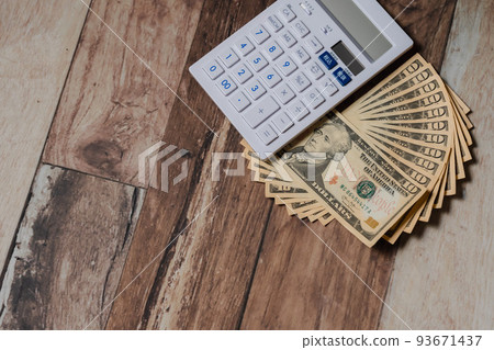 US dollar banknotes and calculator 93671437
