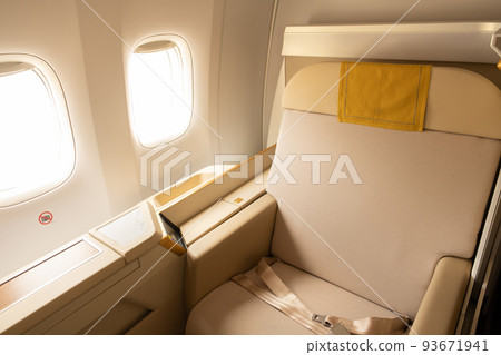 Luxury first class or business class suite on airplane in gold color feel private for travel. Business comfort and eleglance chair when fly with airline. 93671941