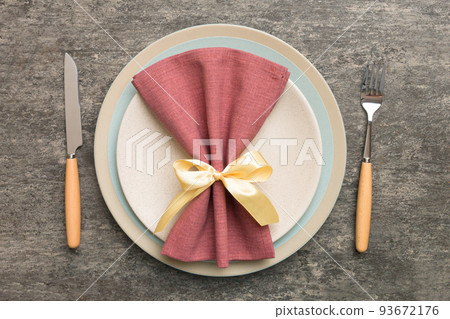 Christmas table place setting with christmas decor and plates, kine, fork and spoon. Christmas holiday background. Top view with copy space Christmas table place setting with christmas decor and plates, kine, fork and spoon. Christmas holiday background. Top view with copy space 93672176