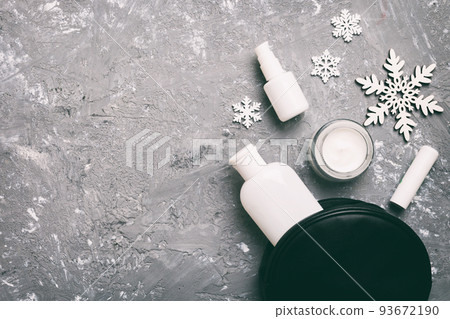 Christmas flat lay with makeup cosmetic products in cosmetic bag on colored background. Top view New year Beauty concept 93672190