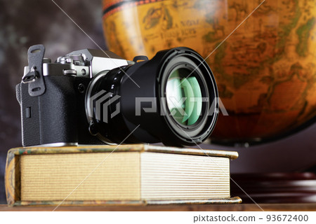 Untitled camera. Close-up photo camera lies on an old book 93672400