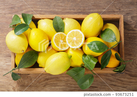 wooden box of fresh lemons with leaves, top view wooden box of fresh lemons with leaves, top view 93673251