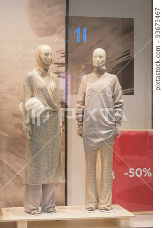 Mannequins in luxury clothes stand in a clothing store. Female mannequins in the big mall. Mannequins in luxury clothes stand in a clothing store. Female mannequins in the big mall. 93673467