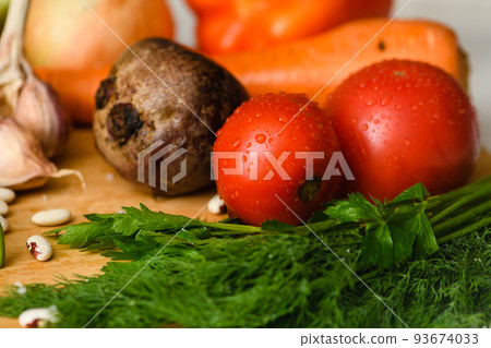 Close-up of tomatoes with various vegetables for cooking borscht. Close-up of tomatoes with various vegetables for cooking borscht. 93674033
