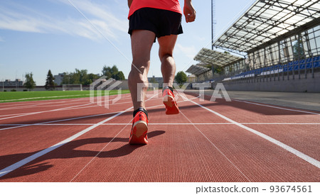 Athlete runner feet running on treadmill closeup on shoe 93674561