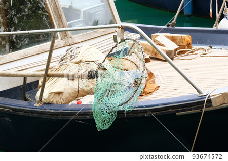 Fishing net on a fishing boat. Equipment on seacoast. Activity of catching fish, either for food or as a sport. 93674572