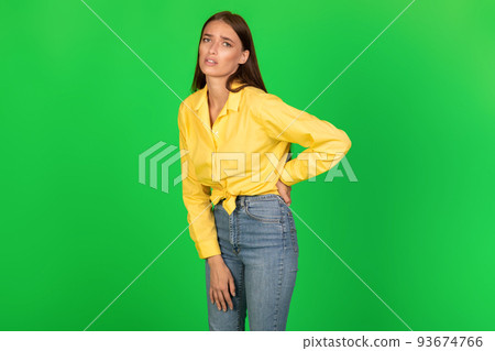 Unhappy Stooped Woman Touching Aching Back Standing Over Green Background 93674766
