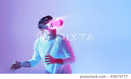 Millennial guy using modern headset, experiencing virtual reality 93674777