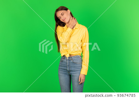 Unhappy Lady Touching Aching Neck Standing Over Green Studio Background 93674785