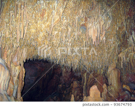 Ancient karst cave with stalactites and stalagmites, Petralona cave Greece Cenote ceiling and limestone decoration. 93674793