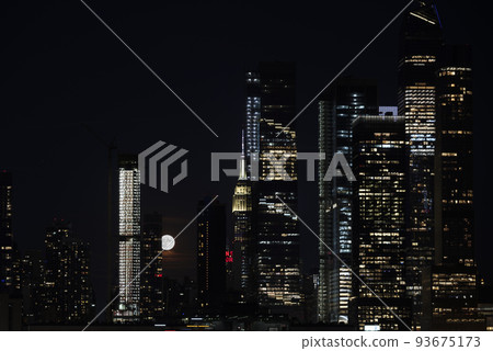 Panoramic view New York City Manhattan Hudson Yard skyscrapers and bright full moon behind buildings  93675173