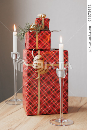 gift boxes in red and green paper packaging on a wooden table. give gifts for Christmas, new year or birthday 93675471