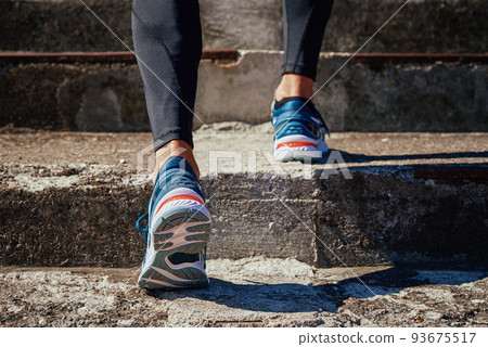 Male sprinter wearing running shoes at concrete stairs background. Sport and fitness runner athlete training at stadium Male sprinter wearing running shoes at concrete stairs background. Sport and fitness runner athlete training at stadium 93675517
