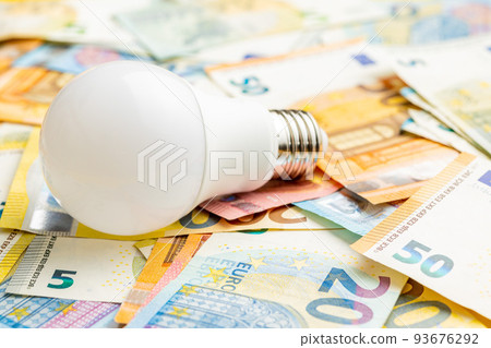 Light bulb and euro money. Concept of increasing electricity prices. Light bulb and euro money. Concept of increasing electricity prices. 93676292