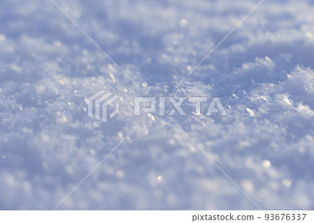 Snowy texture background and snow surface in winter under the sun on a clear frosty day. Snowy texture background and snow surface in winter under the sun on a clear frosty day. 93676337