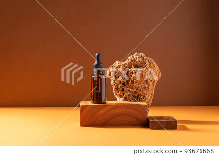 Cosmetic dropper bottle creative modern wood and glass podium. Brown background with hard shadows 93676668