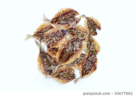 Dried fish with sesame seeds on white background. Dried fish with sesame seeds on white background. 93677662