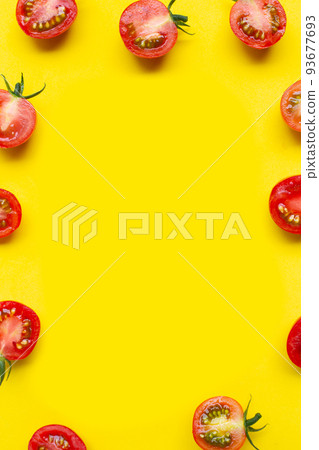 Fresh tomatoes on yellow background. Frame with copy space Fresh tomatoes on yellow background. Frame with copy space 93677693