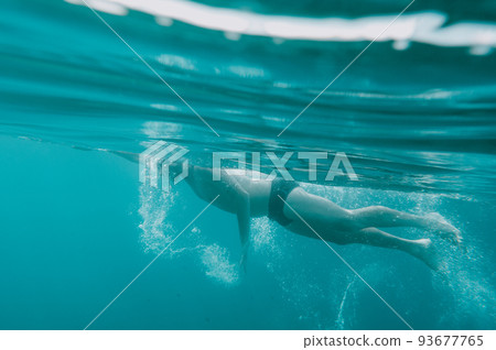 Sporty man swims fast in the sea 93677765