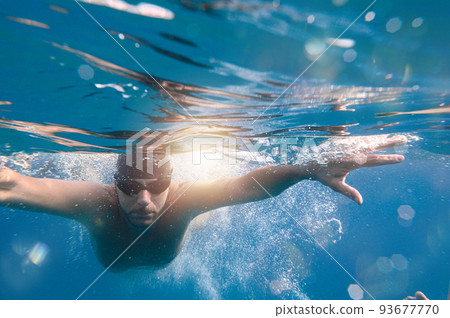 Sporty man swims fast in the sea 93677770