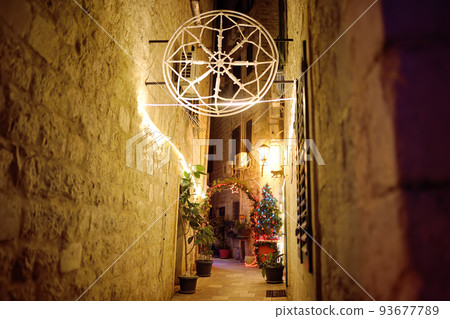 Christmas illumination and decoration on streets of Kotor old town. Christmas Eve in Montenegro. Xmas vacations in Montenegro. 93677789
