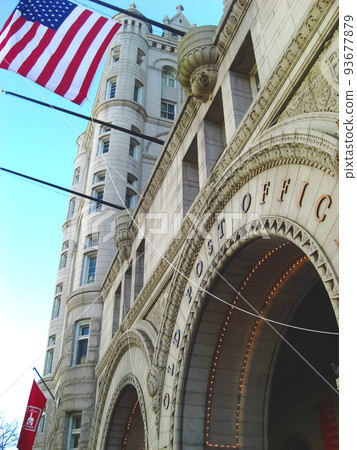 The old post office standing in Washington DC, the capital of the United States, and the Stars and Stripes shining under the blue sky The old post office standing in Washington DC, the capital of the United States, and the Stars and Stripes shining under the blue sky 93677879