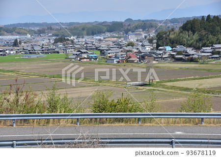 Koka City, Shiga Prefecture, Japan Cityscape seen from the Konan service area Spring cherry blossoms, fields and highways 93678119
