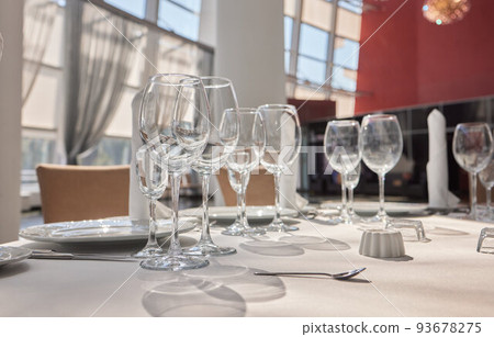 Wine glasses in warm light loft restaurant. 93678275