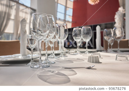 Wine glasses in warm light loft restaurant. 93678276