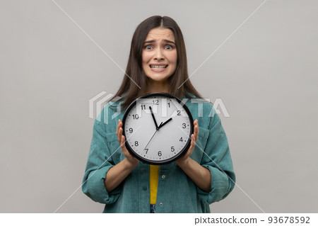 Unhappy Woman Holding Big Clock and Looking Displeased Irritated, Showing  Wall Watches To Hurry Up. Stock Photo - Image of unsure, fear: 254802022