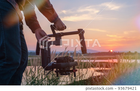 Camera technician working on a gimbal To shoot a movie on a small set to get a smooth finish. 93679421