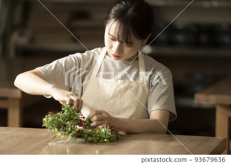 A woman making handmade Christmas reliefs 93679636