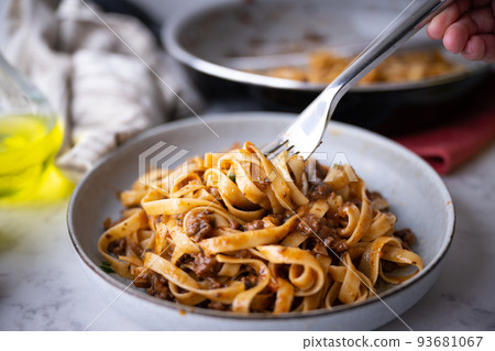 lifting up fettuccine ragu with fork lifting up fettuccine ragu with fork 93681067