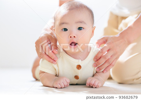 Parent and child practicing tossing and turning Mom's support 3 months old 93682679