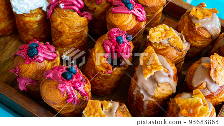 Sweet cruffins from yeast puff pastry with different toppings 93683863