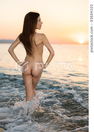 Nude photo of magnificent woman posing on beach 93684103