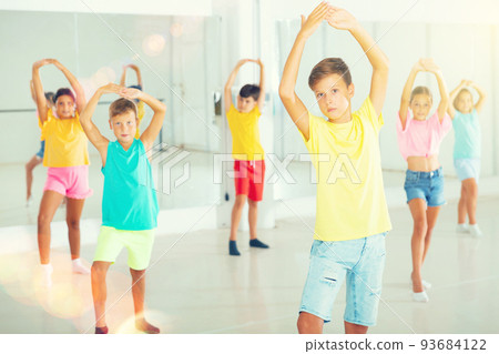 Group of kids training dance moves Group of kids training dance moves 93684122