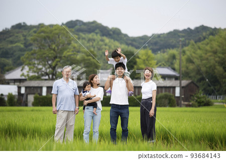 Summer vacation A group photo of a three-generation family returning to their hometown Taken on a footpath in the countryside 93684143