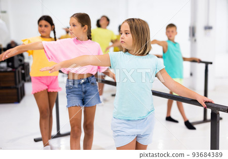 Youth girls and boys training ballet moves in studio 93684389